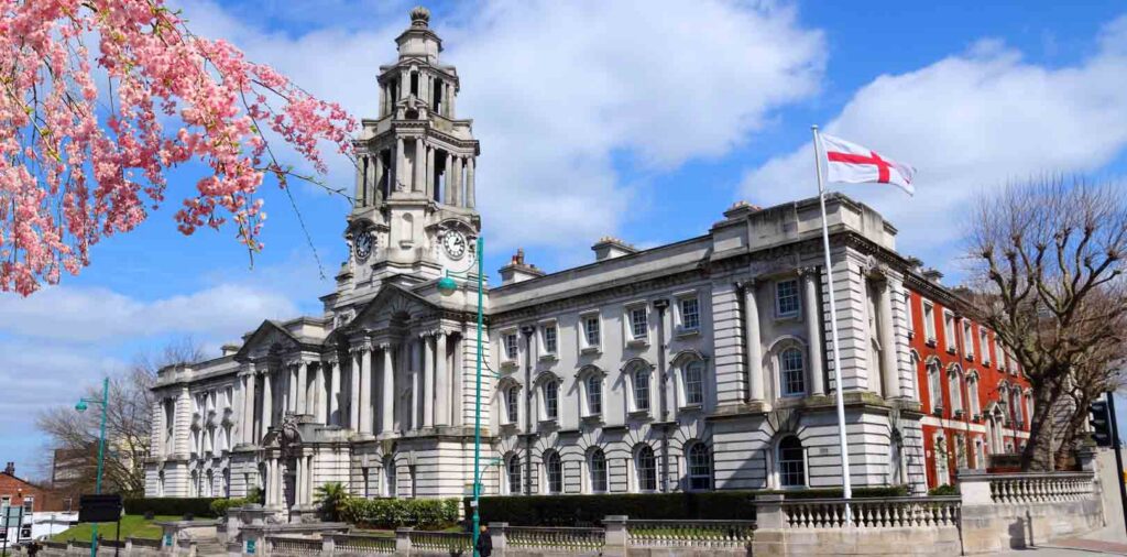 This building is Stockport Town Hall, known locally as the "Wedding Cake" due to its tiered tower.